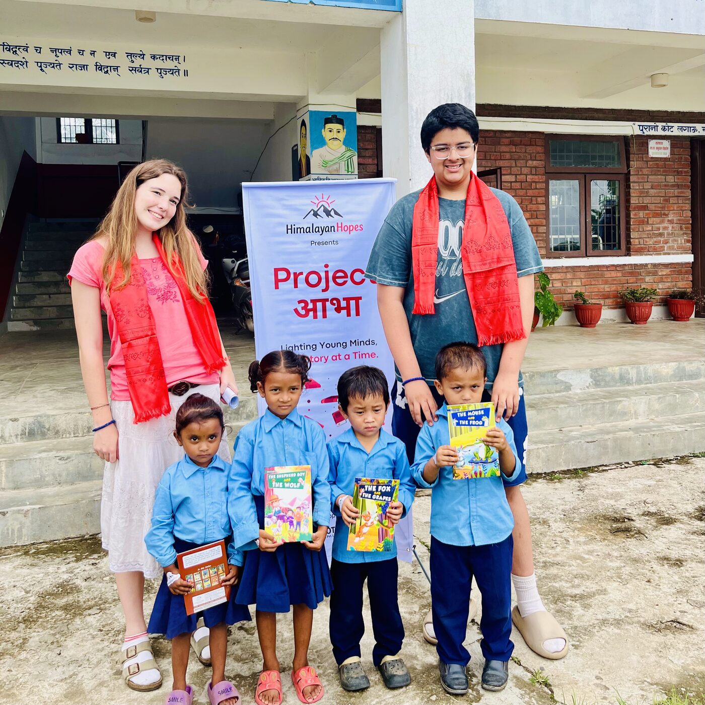 Volunteers with young students holding new storybooks