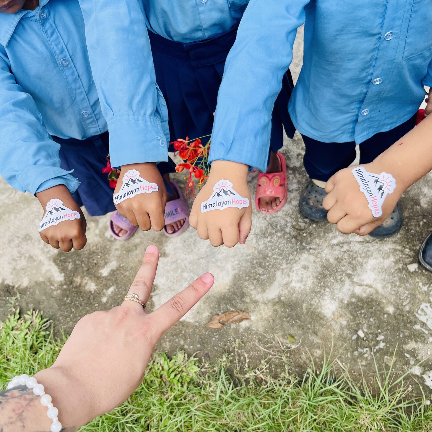 Students proudly showing Himalayan Hopes stickers on their hands